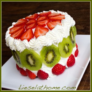 Fancy cake with strawberries and kiwi on a plate