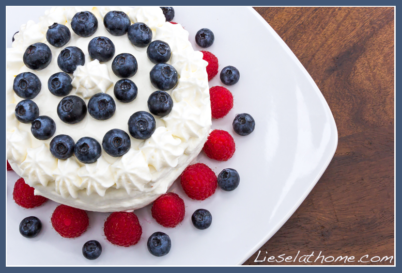 gateau with whipped cream, blueberries and raspberries