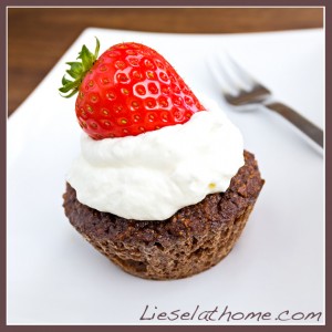 chocolate muffins with whipped cream and a strawberry